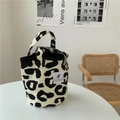 Detail of leopard print canvas tote bag on white table with minimalist lifestyle background - Korean Style Small Bucket Bag
