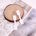 White dumbbell-shaped jewelry price tags on wood background for rings and watches - Square Toe / White
