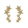 Detailed macro shot of gold brass star earrings with micro-paved cubic zirconia - White