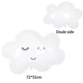Close-up of a white smiley cloud foil balloon with rainbow tassels for party decor - Smiling White Cloud
