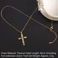 Golden titanium steel cross necklace with colorful zircons on a black leather background - Cross No.39 Gold (A1217)