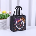 Black non-woven Halloween tote bag featuring a purple hat spider and web design - Halloween Black