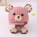 Detail of pink knitted bear hat for kids with earflaps and cute paw print straps - 3-8 Years / Pink