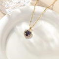 Golden necklace featuring a heart-shaped purple gemstone surrounded by sparkling zircons - Violet Pendant Necklace