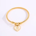 Golden twisted rope bangle with heart enamel pendant featuring letter E detail - Letter E