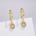 Macro shot of gold-plated hoop earrings with micro-paved white zircon crystal pendants - Letter O (Style: 0229)