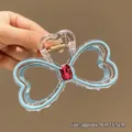 Blue bow hair claw clip with red gemstone and gold spring on a transparent base - Blue Rhinestone Bowknot