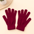 Winter wine red knitted gloves with ribbed cuffs displayed on a warm beige background - One Size / Burgundy