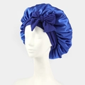 Detail of royal blue satin sleep cap featuring a large decorative bow and silk texture - One Size / Blue