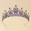 Macro detail of golden bridal crown featuring blue rhinestones and pink teardrop gems - Gold + Blue + Rose Red Rhinestones