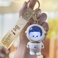 Luminous astronaut cat keychain with golden hardware and Be Happy cream ribbon strap - Glow Astronaut - String Gold Cat
