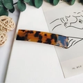 Detail of a rectangular leopard print acetate hair clip with a tortoiseshell pattern - Dark Tortoiseshell