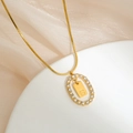 Close-up of gold-plated necklace with oval zircon frame and S letter pendant - S