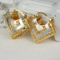 Macro detail of gold and silver shield earrings featuring an intricate Greek Key pattern - Gold Silver Greek Key