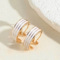 Detail of 14K gold plated C-shaped earrings with white enamel stripes and 925 silver post - White