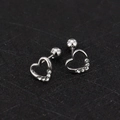 Detailed macro view of silver heart stud earrings with zircons and screw ball backs - Heart - Steel