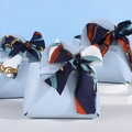 Elegant light blue leather wedding favor bags with decorative dark blue silk scarves - Blue