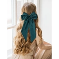 Large green silk bow hair clip on model with elegant long wavy hair in natural light - Spring Clips / Green