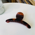 Macro detail of amber tortoise shell hair claw clip with durable resin resin teeth - Matte Red Brown