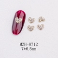 Macro shot of 3D heart-shaped nail gems on a red manicure with full-diamond metal base - Heart Full Rhinestone Gold Style(8712)
