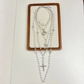 Close-up of layered pearl and silver cross necklaces on a wooden jewelry display stand - Pearl Heart Cross Y2K Layered Necklace
