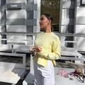 Pale yellow knit sweater with crew neck and side slit hem detail on a model - S / Yellow