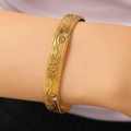 Detailed close-up of gold wide bangle featuring floral embossing and small white crystals - Relief Flower with Diamonds (6974)