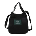 Borsa a secchiello minimalista in tela nera con etichetta verde e tracolla regolabile - Nero