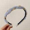 Blue-gray woven headband with golden chain and crystal beads in a hand-held view - Blue Grey