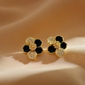 Close-up of elegant gold flower earrings with black enamel and micro-pave crystals - Gold Plated Copper/Enamel/Zirconia / Black Stud Earrings