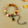 Ethnic vintage bead bracelet with agate, bone elements and a colored woven tassel charm - Style F: Pink Glaze Vajra Cinnabar Zaki Lhamo Bracelet