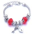 Silver charm bracelet featuring faceted red beads with heart lock and key pendants - Red