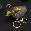 Vintage enamel dragon keychain with sparkling yellow rhinestones on a textured stone base - Yellow