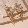 Macro shot of gold tassel earrings with shimmering cubic zirconia on stone background - Gold Zirconia Tassel Earrings / Gold