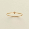 Close-up of minimalist gold ring featuring a small round orange zircon birthstone - US 7 / November (Orange Zircon)