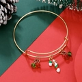 Detail of adjustable gold Christmas bracelet with festive cane charm and pine cone decor - Christmas Candy Cane (D1365)