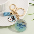 Detail of keychain with light blue suede tassel and resin charm featuring dog mom text - Style 8-Shiba Inu with Light Blue Tassel and Blue-Green Glitter Dog Mom