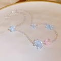 Handmade beaded necklace with blue flower beads and a pink heart pendant on white plate - Blue Flower Pink Heart Acrylic Style