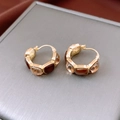 Close-up of vintage gold huggie earrings with champagne crystals on silk - Gold & Coffee Brown Ear Buckle
