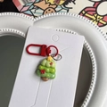 Detail of a Christmas tree keychain in green resin on white fashion jewelry card - Christmas Tree