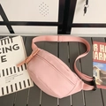 Pink canvas crossbody bag with adjustable strap and braided zipper pull on a stool - Pink