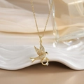 Elegant gold-plated bird pendant necklace with sparkling cubic zirconia on wavy tray - FN0101 Sparkling Pigeon With Ring