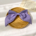 Detailed view of a large purple fabric bow hairclip on a decorative wooden tray - Two-Layer Bow Spring Clip / Purple