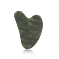 Detailed view of heart-shaped dark green resin gua sha tool with natural texture and reflection - Jade / Emerald