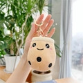 Close-up of a cute bubble tea plush keychain with smiling face and golden metal ring - Big Eyes/Gold Buckle / Brown