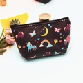 Detail of a purple unicorn coin purse showing colorful rainbow prints and a smooth black zipper - Unicorn-8