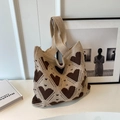 Close-up of knit tote bag with heart patterns showing detailed weaving and texture - Brown