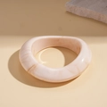 Detail of cream marbled resin cuff bracelet with a wide geometric open design - Beige Oval (Marble Pattern)