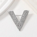 Sparkling silver V-shaped letter brooch with white rhinestones on a minimalist background - Silver Letter V Pave Rhinestone Brooch (YNCP5779)
