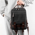 Zaino vintage in tela nera con finiture in pelle marrone e tasche multifunzionali - Nero